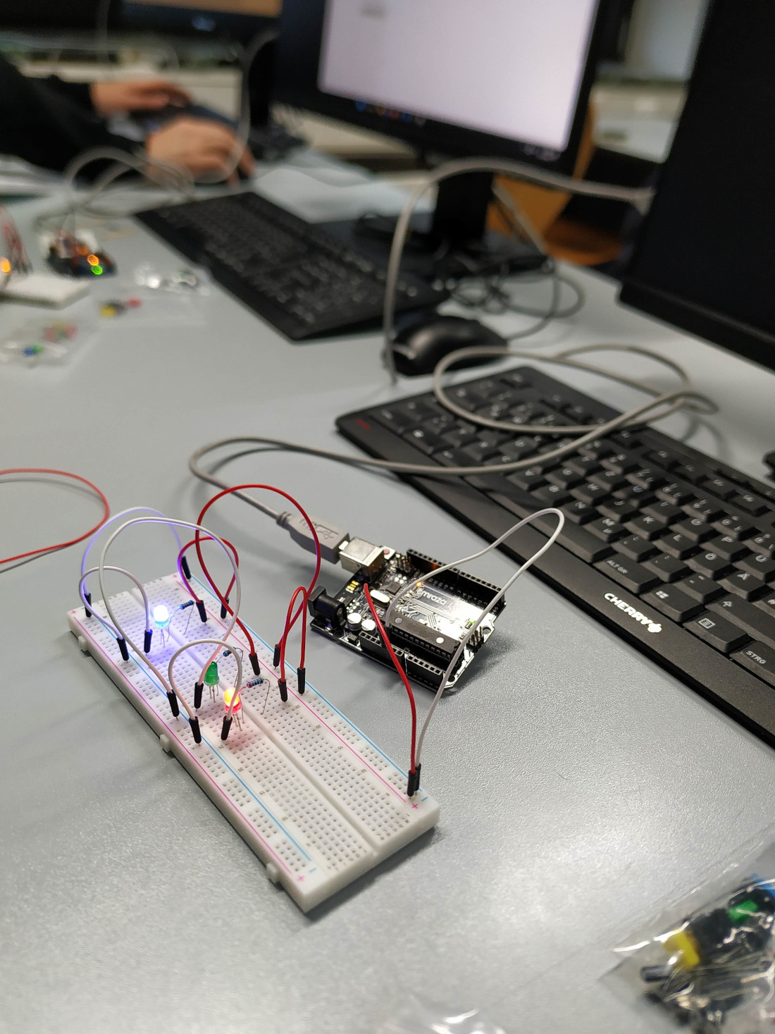 Bunte LEDs leuchten auf einem Steckbrett mit einem Arduino.